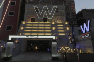 名古屋的住宿－W拉鍊俱樂部設計酒店，带有读wfw俱乐部标志的建筑