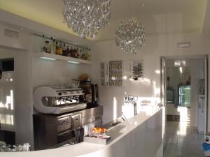 a kitchen with two chandeliers and a counter at Plaza Rooms in Avola