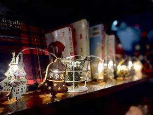a shelf with christmas ornaments and books on it at hotel the textile in Gifu +58 photos