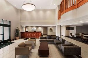 a lobby with couches and a table in a building at Wingate by Wyndham Bridgeport Clarksburg in Bridgeport