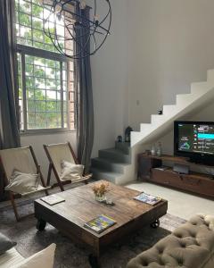 a living room with a table and a tv at Antique Barraca in Concepción del Uruguay