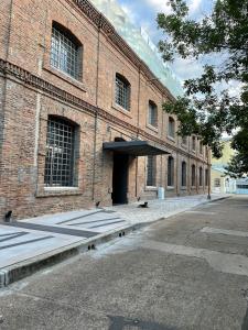 a large brick building with a door on a street at Antique Barraca in Concepción del Uruguay