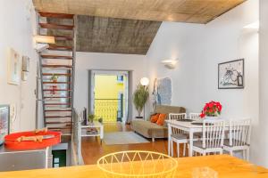 a kitchen and living room with a table and chairs at Bocage Loft (Setúbal downtown) in Setúbal