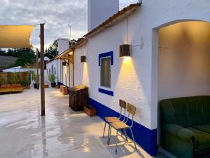 a building with a couch and chairs in front of it at Casa Amador Charming 2 bedrooms house in Alcacer in Alcácer do Sal