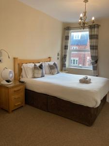 a bedroom with a large bed and a window at Pepper Street Rooms in Whitchurch