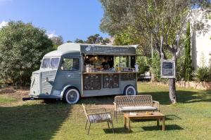 a food truck parked in a grassy area next to a tree at Résidence Casarina in Bonifacio