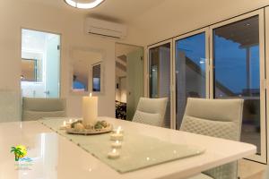 a dining room with a table with candles and chairs at Villa Green Palm in Vrsar