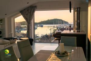 a dining room with a view of a marina at Villa Green Palm in Vrsar