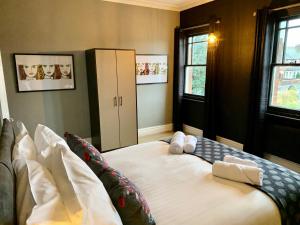 um quarto com uma cama grande com duas toalhas em Stamer House by YourStays, Stylish quirky house, with 4 double bedrooms, BOOK NOW! em Stoke-on-Trent