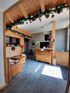 a large room with a kitchen with a table at Au Cœur des Lacs - Chambres d'hôtes & spa in Gérardmer