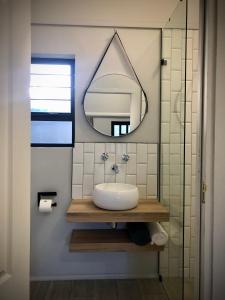 a bathroom with a sink and a mirror at Modern Goldfields Apartments in Virginia +31 photos