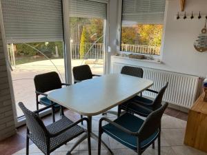 a dining room with a table and chairs at Sunhouse, Balatonvilágos in Balatonvilágos