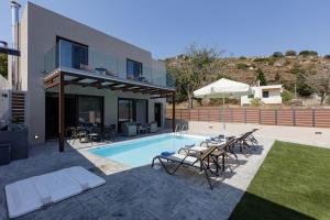 a house with a swimming pool next to a house at Fotinou Villa, a secret retreat, By ThinkVilla in Fotinós