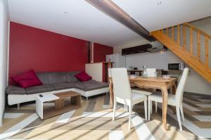 a living room with a couch and a table at Gîtes d'Amelyann - gitesdesbalcons-com in Panossas