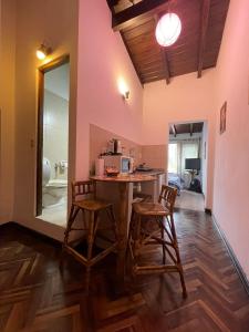 a kitchen with a table and stools in a room at Apartment Salta 2 pax in Salta
