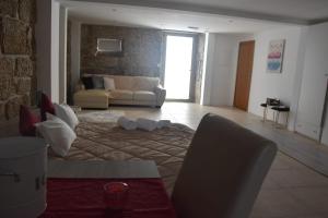 a living room with a couch and a table at DIGNUS HOUSE in Folhadosa +25 photos