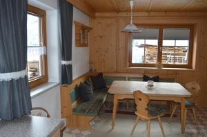 a dining room with a table and chairs and a window at Haus Oblasser in Brandberg