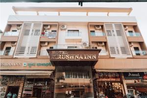 a building with a sign for a kushinian inn at Hotel Krushna Inn in Trimbak