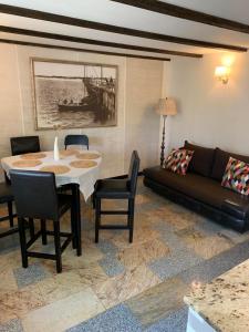 a living room with a table and a couch at Alėjos Namelis in Palanga