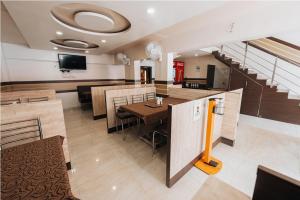 a dining room with a table and a tv at Hotel Krushna Inn in Trimbak