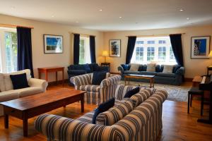 a living room with couches and chairs and a table at Rookley Farm Lodge - Pet friendly in Rookley