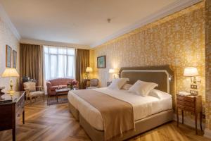 a hotel room with a bed and a living room at Relais & Châteaux Hotel Orfila in Madrid