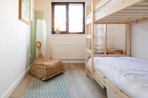 a bedroom with a bunk bed and a chair at Stylish apartment with balcony, minutes from beach in Redcar