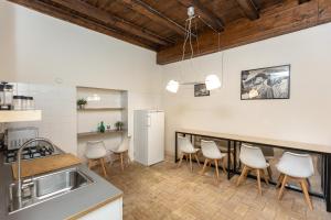 kuchnia z barem z białymi krzesłami w obiekcie Rome Historical Apartment - Arco dei Banchi w Rzymie