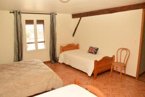 En eller flere senge i et værelse på Gite La Sente des Vignes
