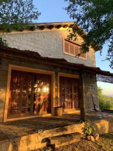 a stone house with a bench in front of it at CABAÑA EN TANTI in Tanti