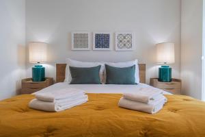 a bedroom with a bed with towels on it at Stunning Apartment in Heart of Lisbon by LovelyStay in Lisbon