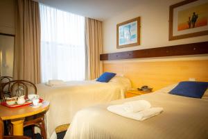 Letto o letti in una camera di Ashley Hotel