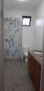 a bathroom with a toilet and a glass shower at Ocean rush barracuda in Zinkwazi Beach