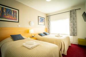 Letto o letti in una camera di Ashley Hotel