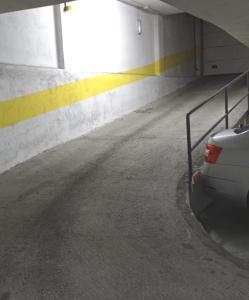 a car is parked in a parking garage at Apartamento Casa Lomberte in Allariz