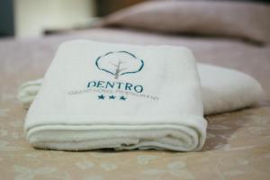 A bed or beds in a room at Grand Hotel Dentro