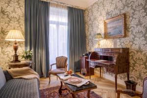 a living room with a piano and a table at Relais & Châteaux Hotel Orfila in Madrid