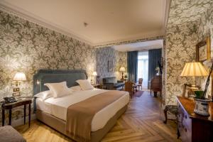 a bedroom with a bed and a living room at Relais & Châteaux Hotel Orfila in Madrid