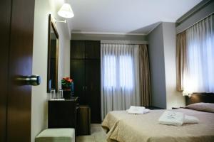 A bed or beds in a room at Grand Hotel Dentro