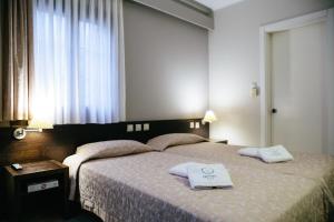 A bed or beds in a room at Grand Hotel Dentro