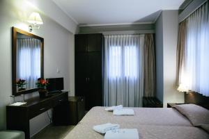 A bed or beds in a room at Grand Hotel Dentro
