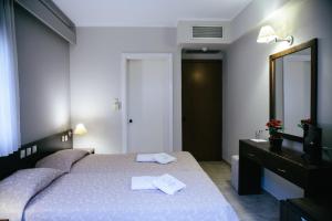 A bed or beds in a room at Grand Hotel Dentro