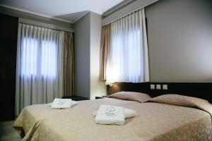 A bed or beds in a room at Grand Hotel Dentro