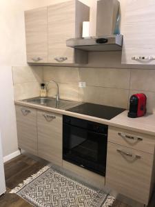 a kitchen with a sink and a stove top oven at ATELIER in Voghera