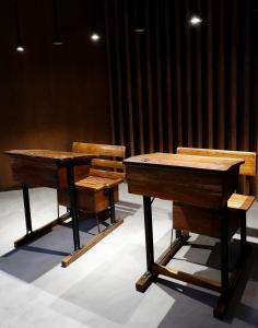 two desks and a bench in a room at O Cantinho do Colégio - Dourocollege in Lamego