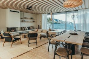 a living room with a couch and a table and chairs at Maslina Resort in Stari Grad