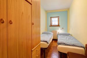 Ένα ή περισσότερα κρεβάτια σε δωμάτιο στο Chalet Meridiana Appartamento 3