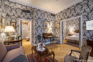 a hotel room with a bed and a living room at Relais & Châteaux Hotel Orfila in Madrid