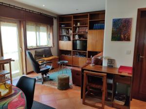 a living room with a desk and a chair at Yellow House in Senhora da Hora