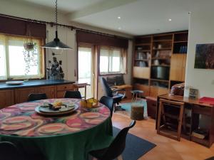 a living room with a table and chairs at Yellow House in Senhora da Hora